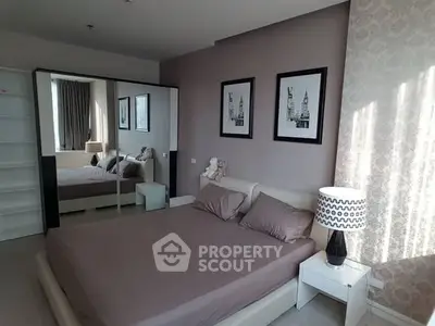 Modern bedroom with stylish decor and mirrored wardrobe