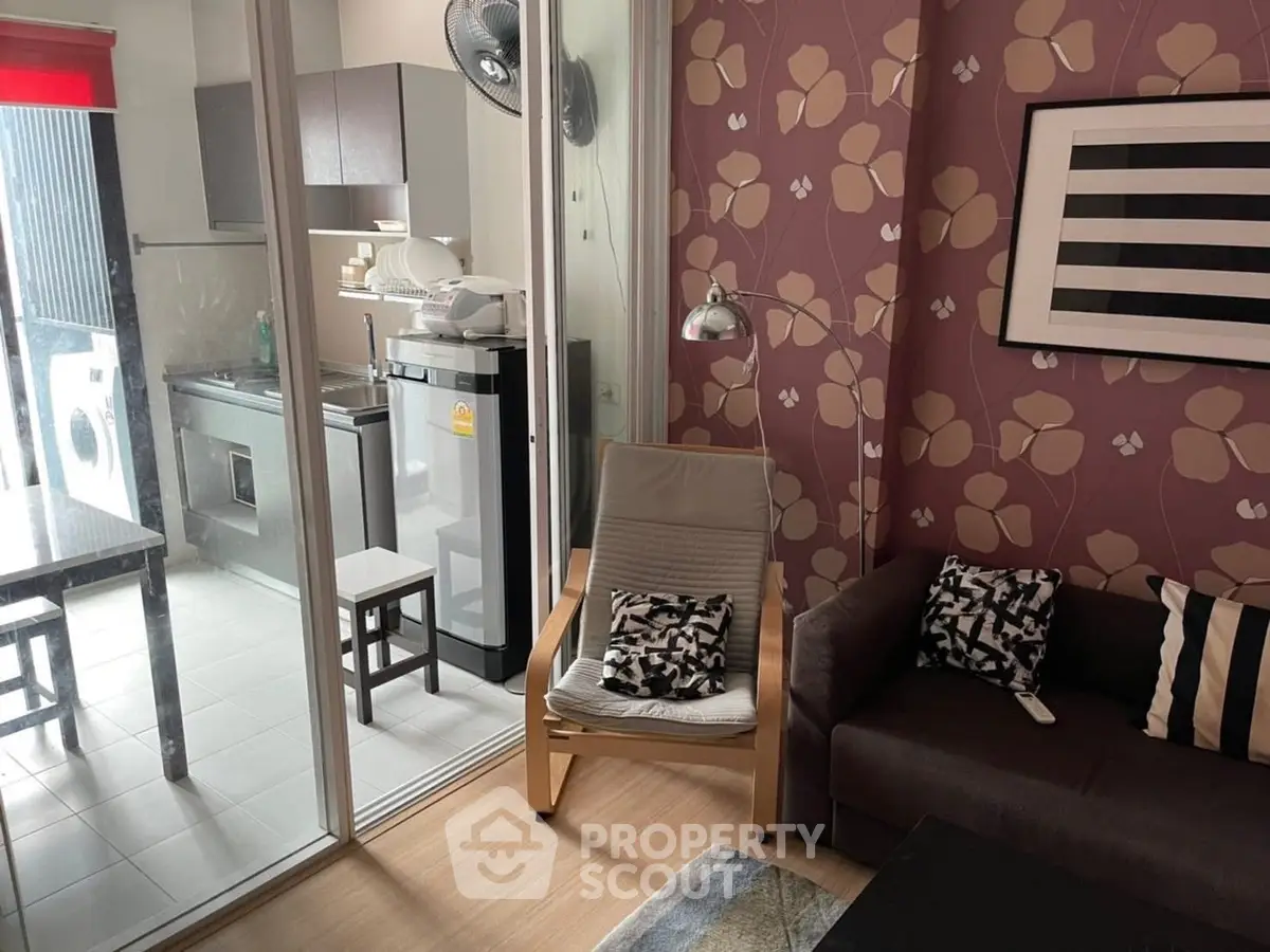 Chic living room with floral wallpaper and modern kitchen view