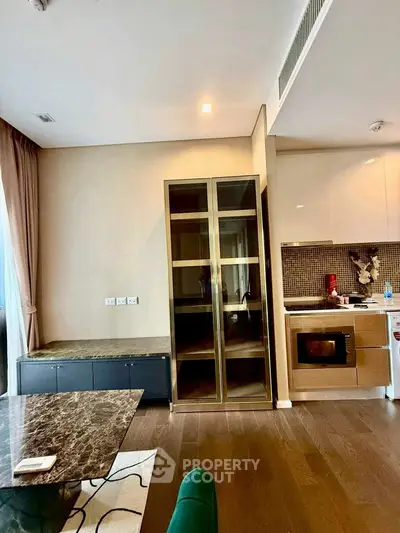 Modern kitchen with sleek appliances and stylish cabinetry in a contemporary apartment.