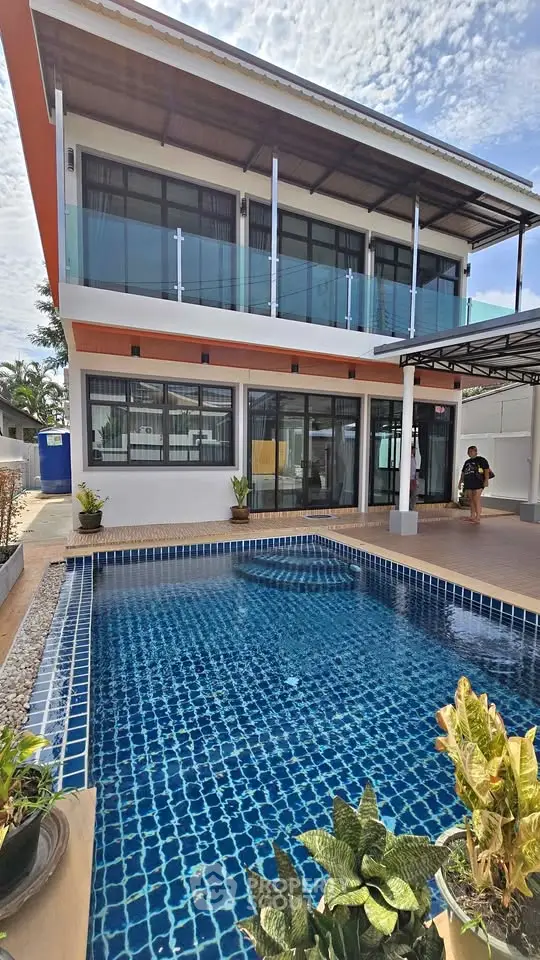 Stunning modern two-story home with private pool and spacious balcony, perfect for luxurious living.