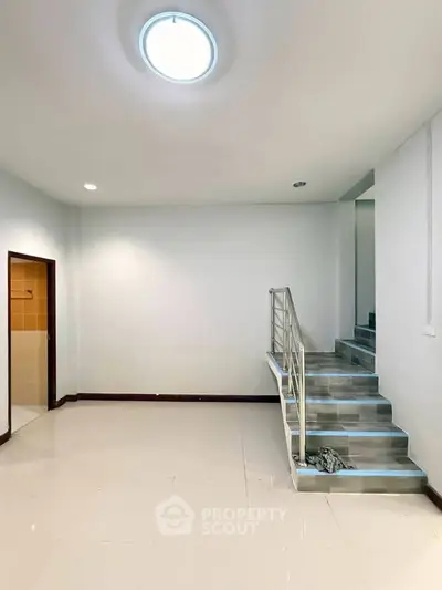 Modern interior with sleek staircase and bright lighting, perfect for contemporary living.