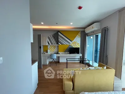 Modern living room with stylish decor and balcony access in a contemporary apartment.