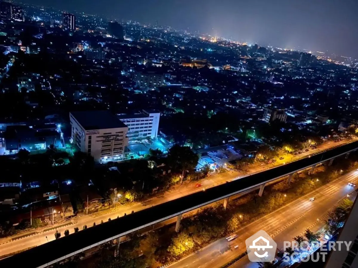 Stunning cityscape night view from high-rise building showcasing vibrant urban lights.