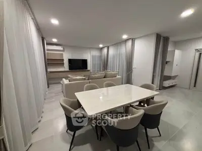 Spacious modern living room with elegant dining area and neutral decor