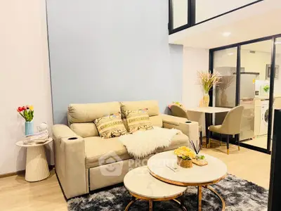 Modern living room with cozy beige sofa, stylish coffee table, and elegant dining area in open layout.