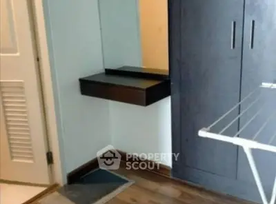 Compact bedroom corner with wardrobe and drying rack