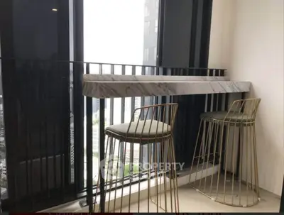 Stylish modern balcony with chic bar stools and city view, perfect for urban living.