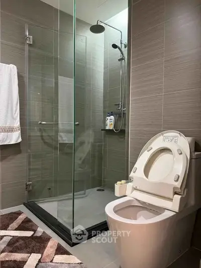 Modern bathroom with glass shower and sleek toilet design