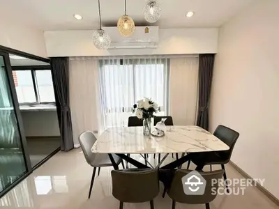 Elegant dining room with marble table and modern lighting in a stylish apartment