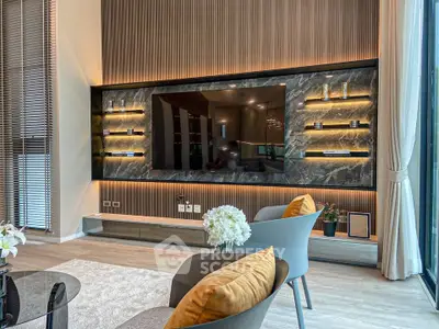 Luxurious modern living room with elegant decor and large TV display, perfect for relaxation and entertainment.