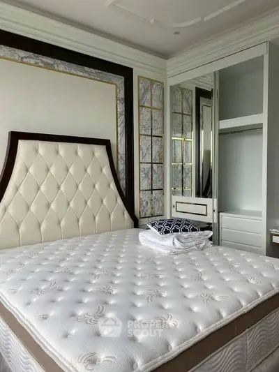 Luxurious bedroom with elegant headboard and built-in closet, perfect for modern living.