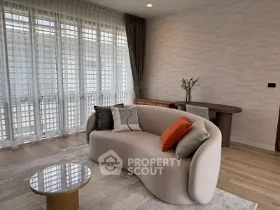 Modern living room with stylish sofa and floor-to-ceiling windows