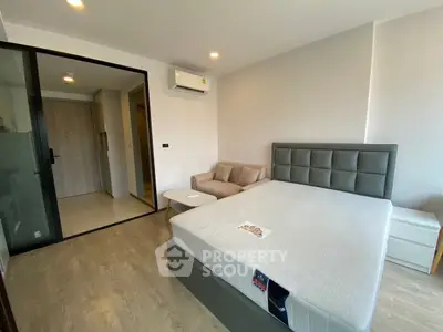 Modern bedroom with sleek design, featuring a comfortable bed, cozy sofa, and stylish decor.