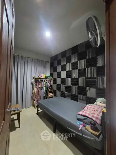 Cozy bedroom with modern acoustic panel wall and simple furnishings