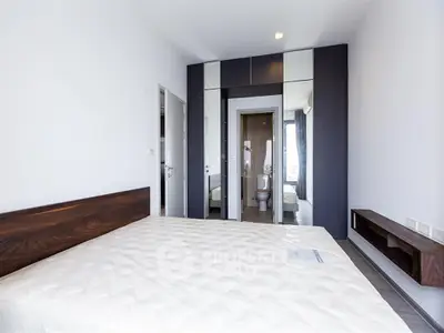 Modern bedroom with ensuite bathroom and sleek wardrobe design
