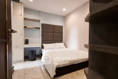 Cozy bedroom with modern furnishings and ample storage space, perfect for a comfortable living experience.