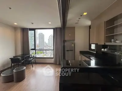 Modern open-layout kitchen with city view, sleek countertops, and dining area in a high-rise apartment.