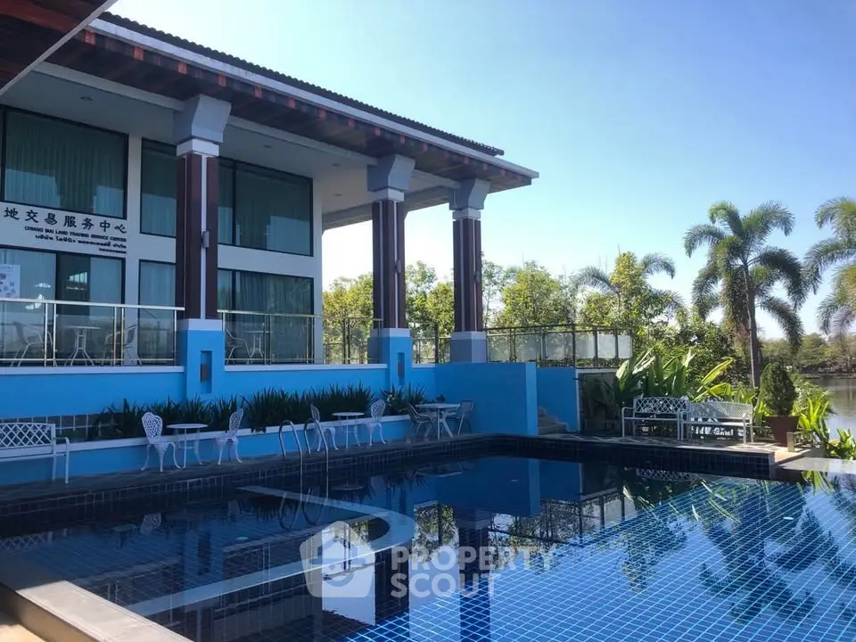 Luxurious poolside view of modern villa with lush greenery and serene ambiance.