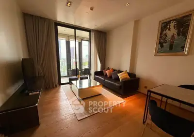 Modern living room with large windows and city view, featuring sleek furniture and elegant decor.