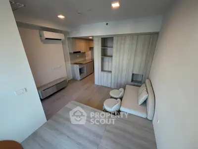 Modern living room with open kitchen and stylish furniture in a contemporary apartment.