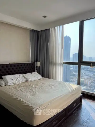 Spacious bedroom with city view and modern furnishings