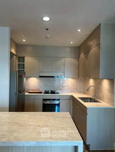 Modern kitchen with sleek cabinetry and built-in appliances