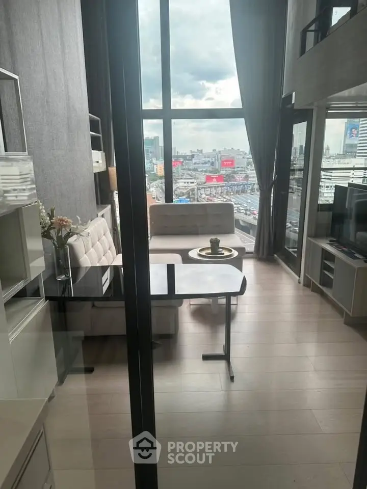 Modern living room with large windows offering stunning city views