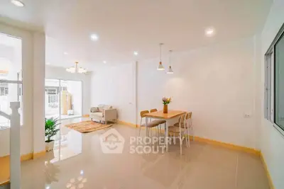 Spacious open-plan living and dining area with modern decor and natural light.