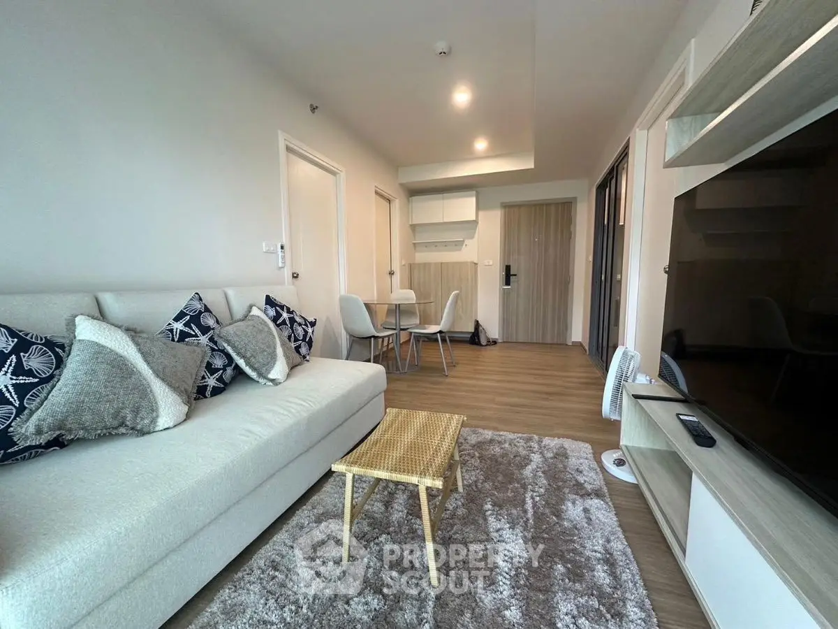 Modern living room with cozy sofa and stylish decor in a contemporary apartment.