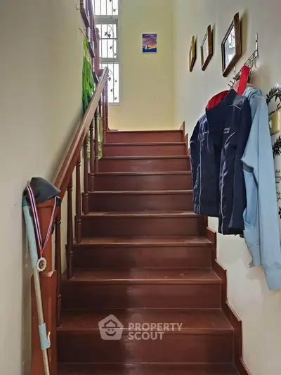 Charming wooden staircase with natural light and cozy decor accents