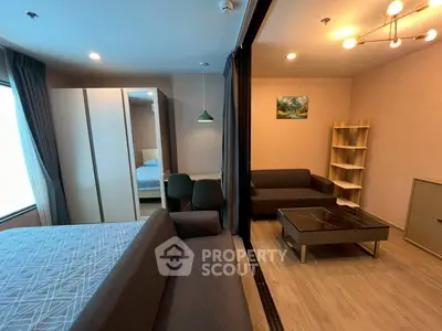 Modern studio apartment with stylish living area and cozy bedroom