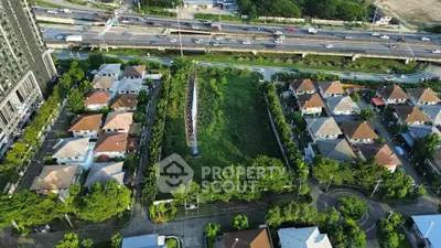 Aerial view of suburban residential area with lush greenery and well-planned houses.