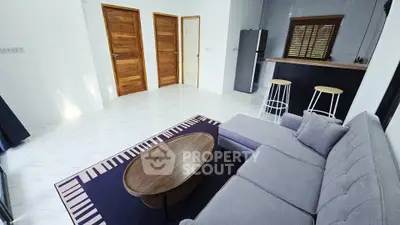 Modern living room with stylish furniture and open kitchen layout