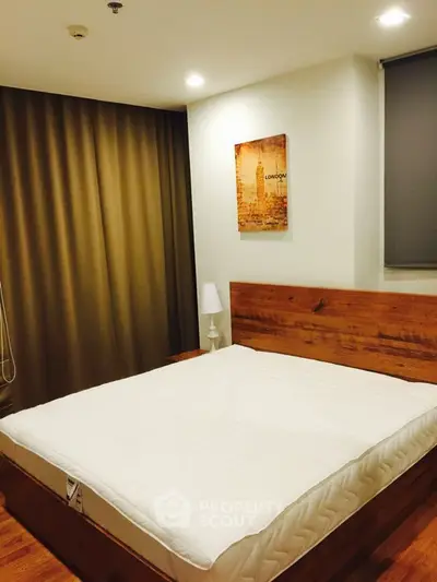 Cozy bedroom with a large bed, wooden headboard, and elegant decor, perfect for restful nights in a modern home.