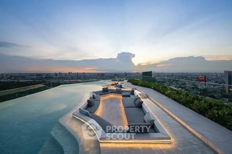 Luxurious rooftop pool with stunning city skyline view at sunset, featuring elegant seating area.
