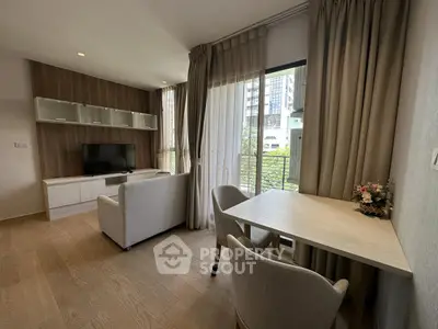 Modern living room with large windows and stylish furniture in a high-rise apartment.