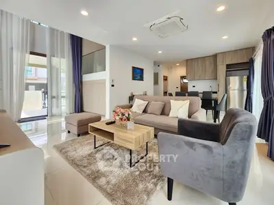 Modern living room with stylish furniture and open kitchen layout