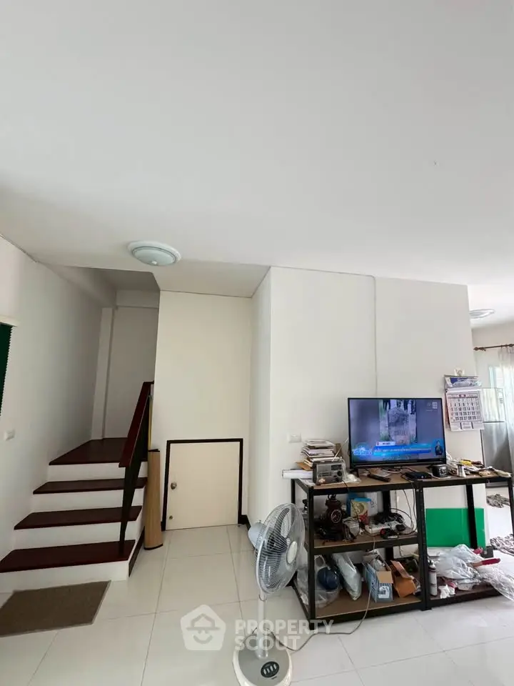 Spacious living area with modern decor and entertainment setup