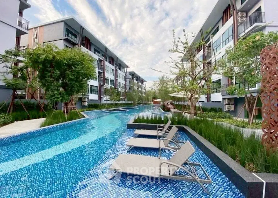 Luxurious apartment complex with stunning pool and modern architecture