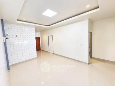 Spacious modern living room with sleek tile flooring and recessed lighting
