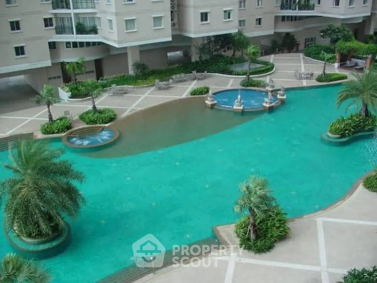 Luxurious apartment complex with stunning pool and lush greenery