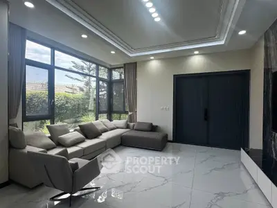 Spacious modern living room with large windows and elegant furniture