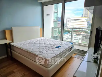Modern bedroom with city view and large windows in a high-rise apartment.