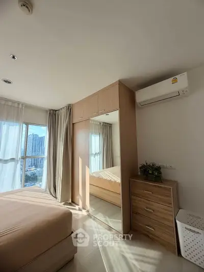 Modern bedroom with city view, mirrored wardrobe, and air conditioning