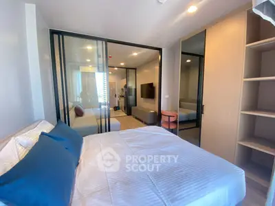 Modern bedroom with glass partition and stylish decor in a contemporary apartment.