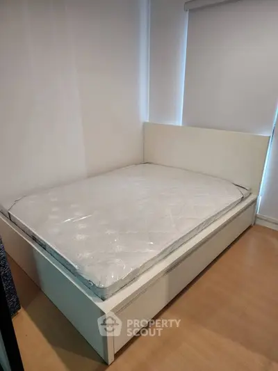 Modern bedroom with sleek white bed and minimalist design