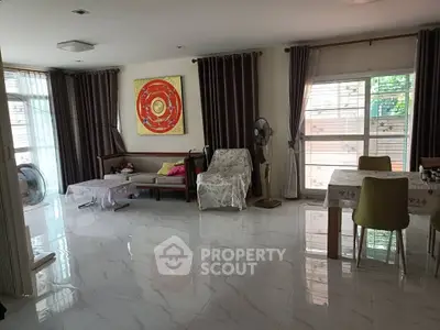 Spacious living room with modern decor and large windows for natural light.
