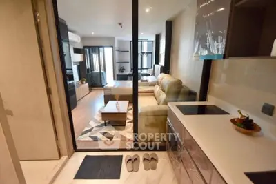 Modern open-layout living room with stylish kitchen and cozy seating area in a contemporary apartment.