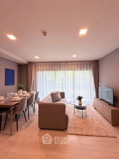 Spacious modern living room with elegant decor and large windows for natural light.