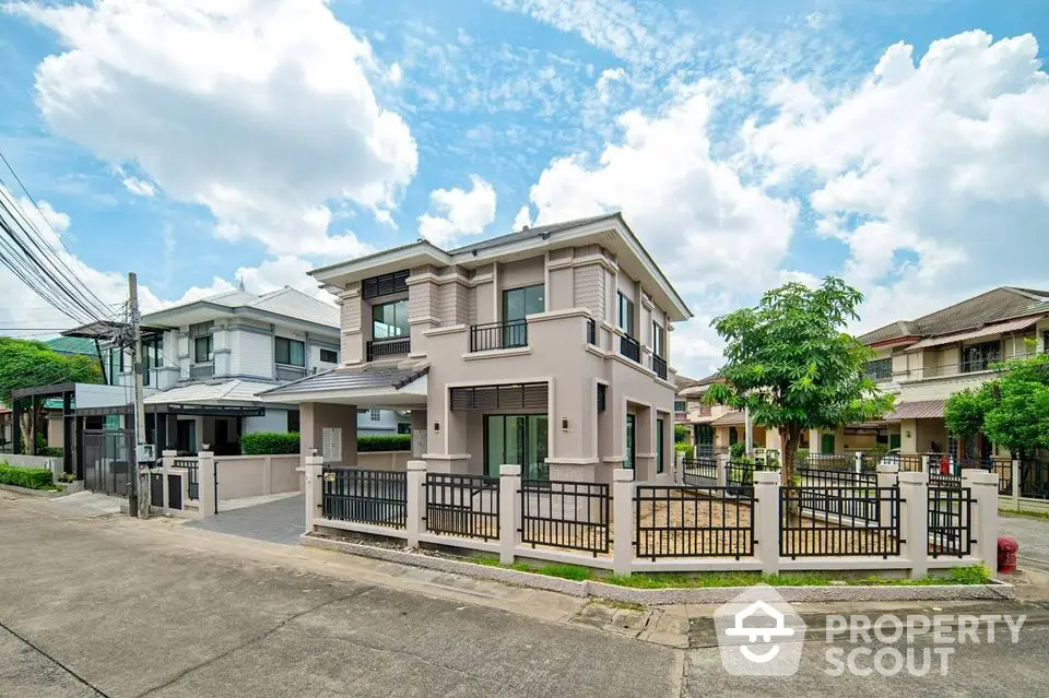 Modern two-story house with fenced yard and spacious driveway in suburban neighborhood.